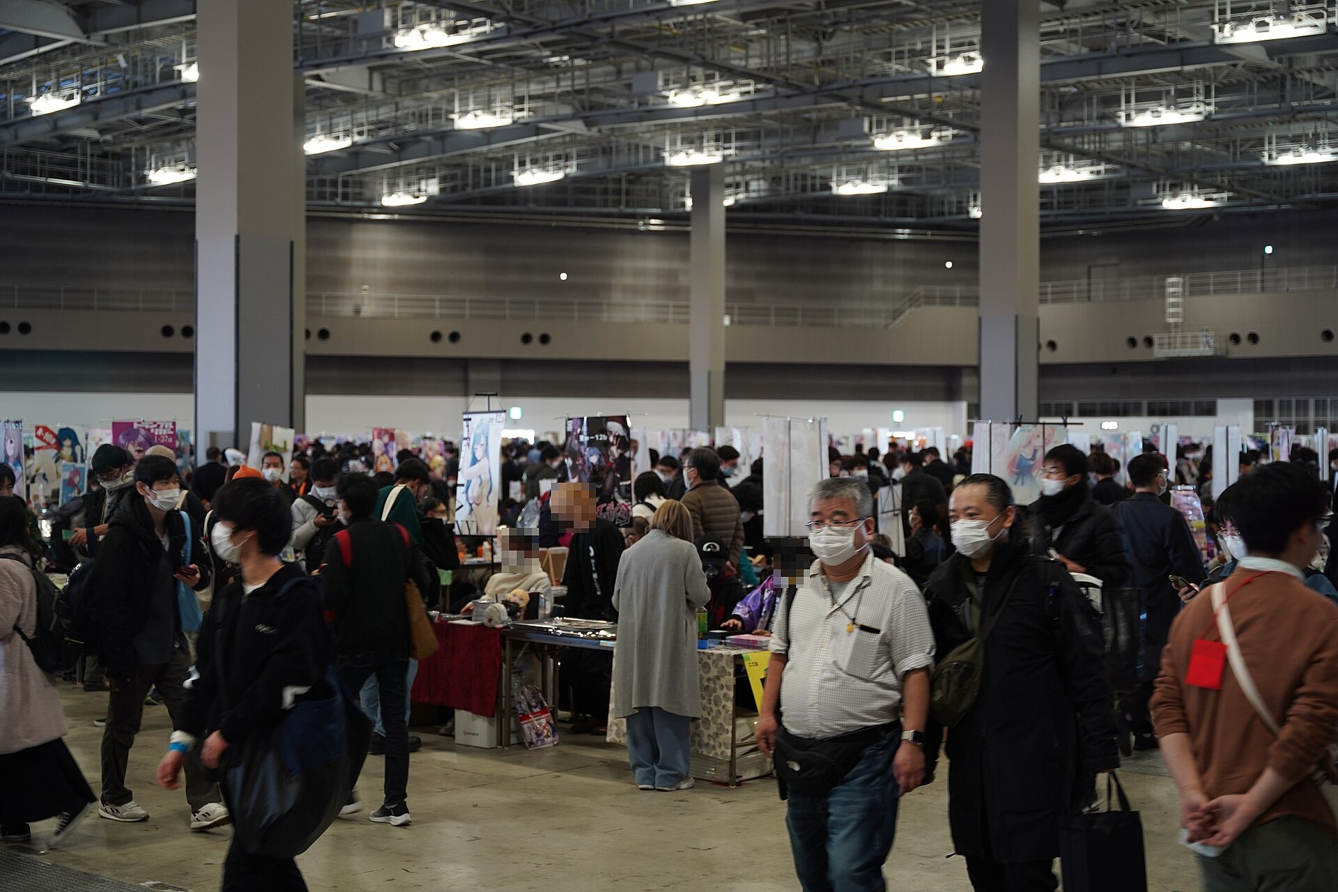 Circle tables and visitors in an East Hall at Winter Comiket C105, 29 December 2024.