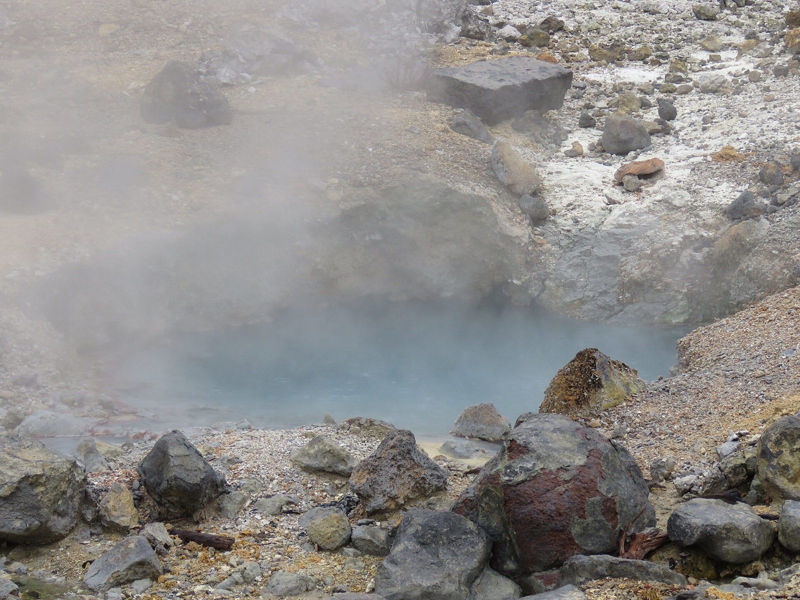 A close view of hot water and steam in the volcanic valley.