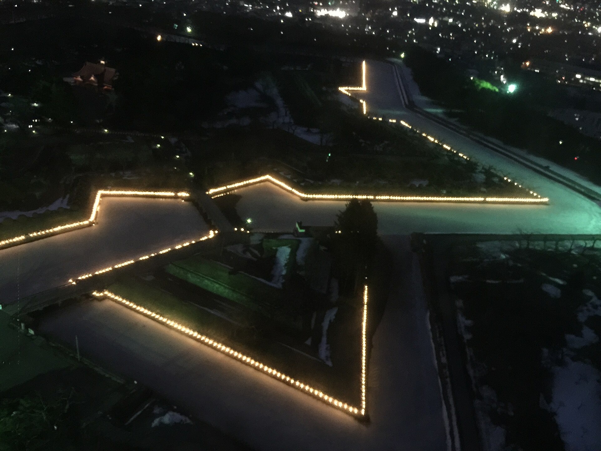 The illuminated star-shaped moat of Goryokaku on a winter evening, viewed from Goryokaku Tower in 2015.
