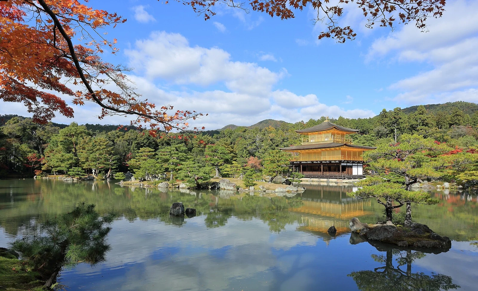 Autumn colour frames the pond and pavilion.