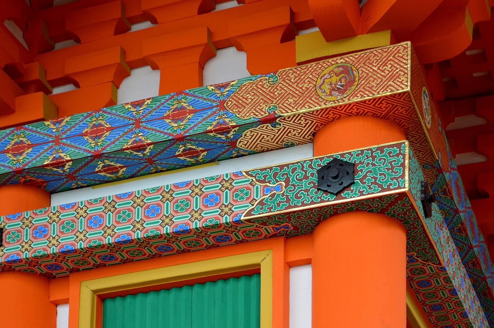 Painted details beneath the eaves of the three-storey pagoda.
