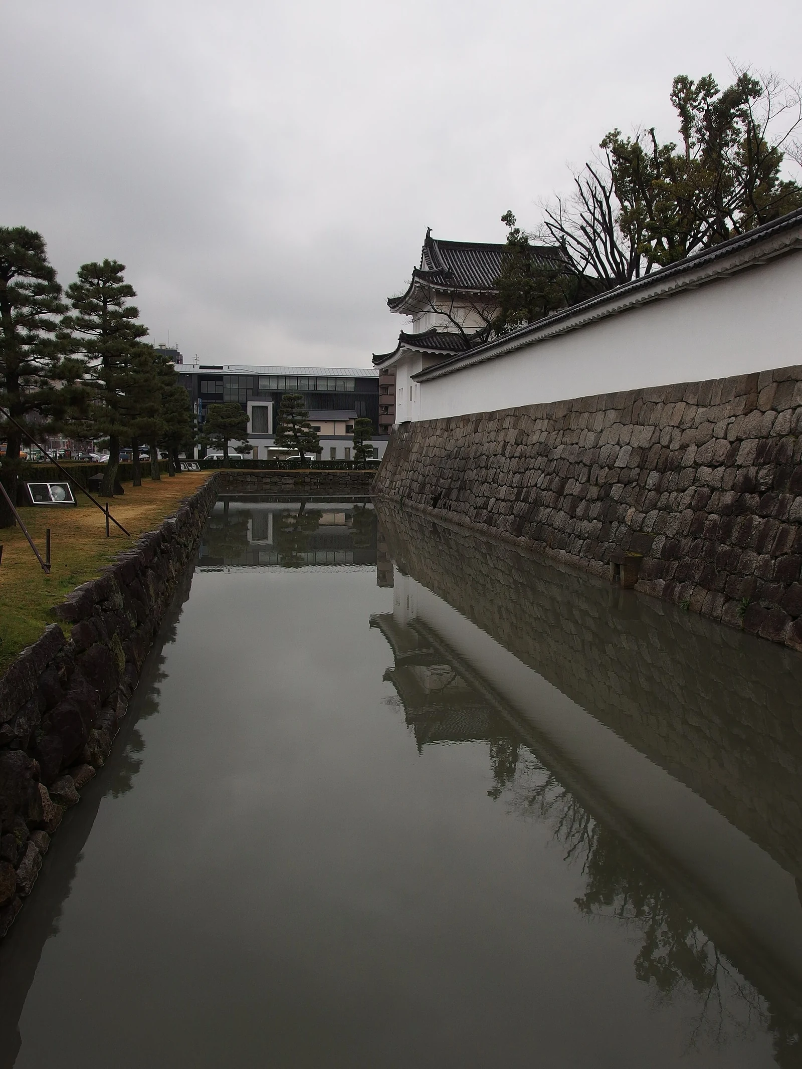 Stone walls and a quieter view along the moat.