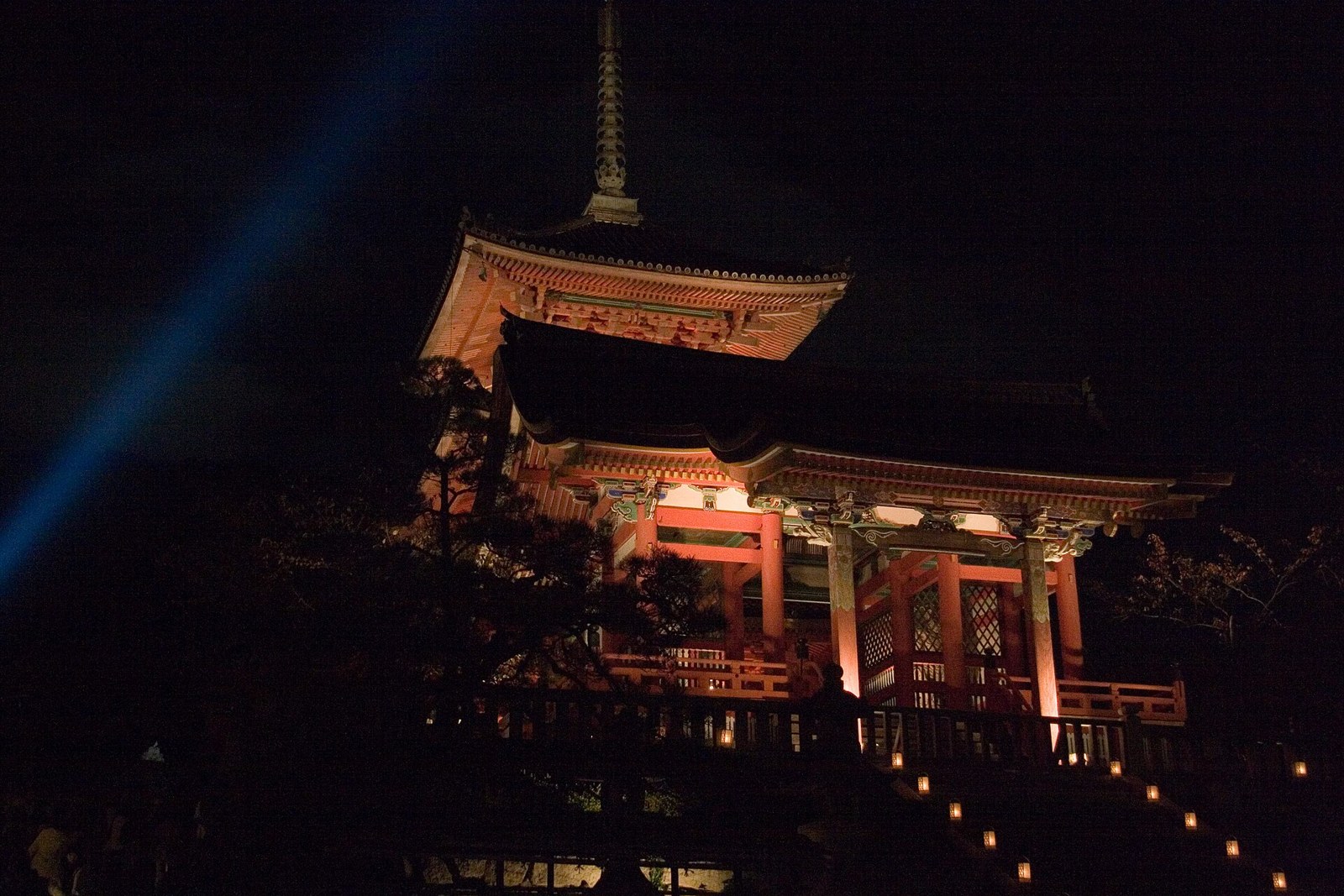 The pagoda and gate illuminated after dark.