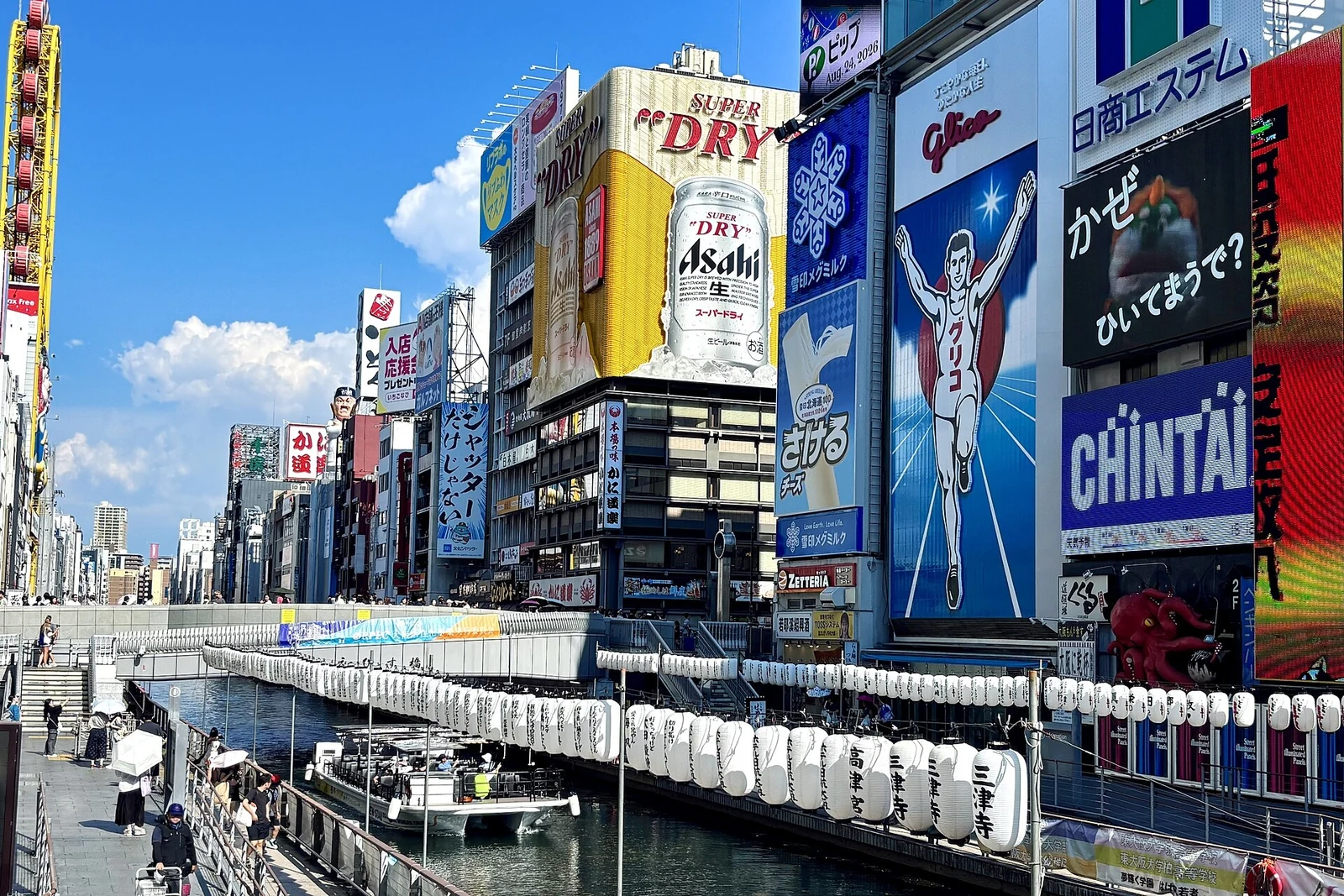 Dotonbori canal and its landmark signs on a summer afternoon.