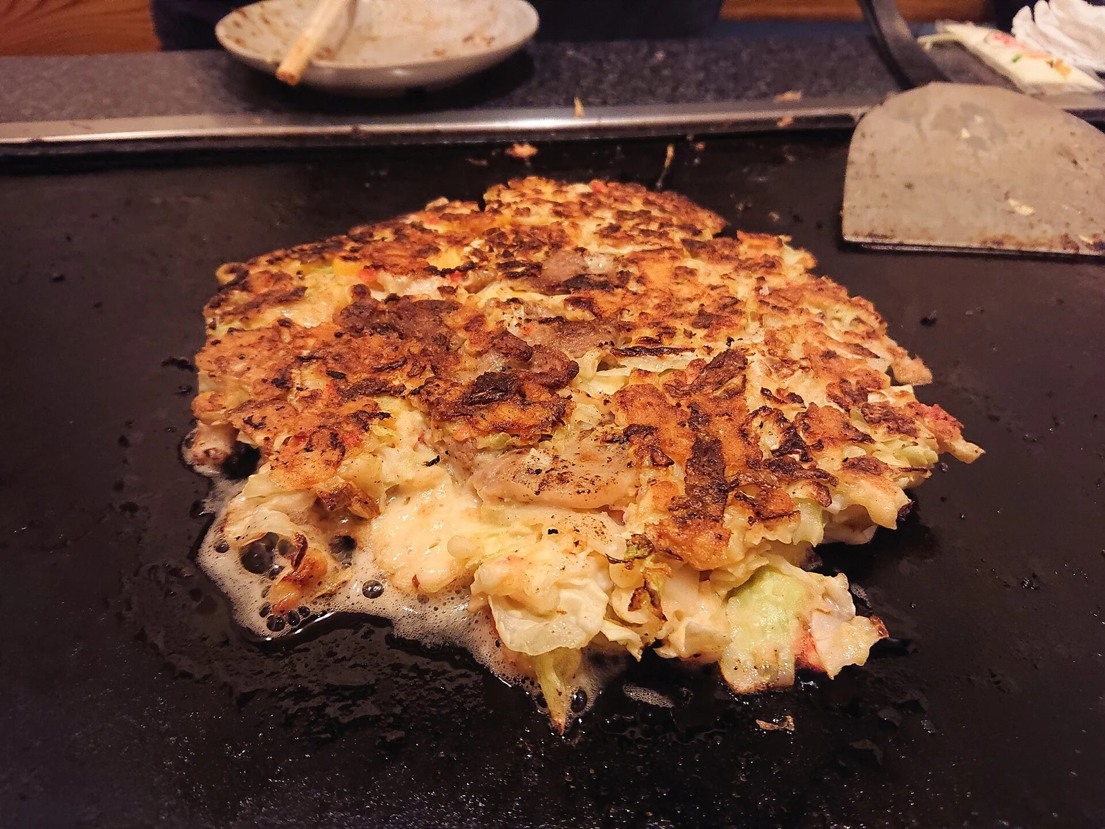 Okonomiyaki on a hotplate in Namba.