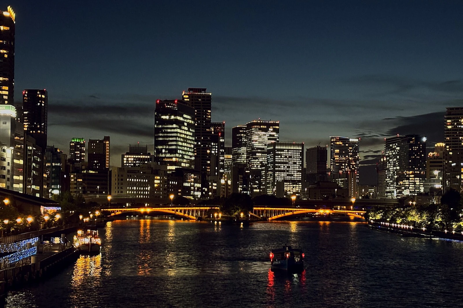 Lights along the Nakanoshima waterfront at dusk.