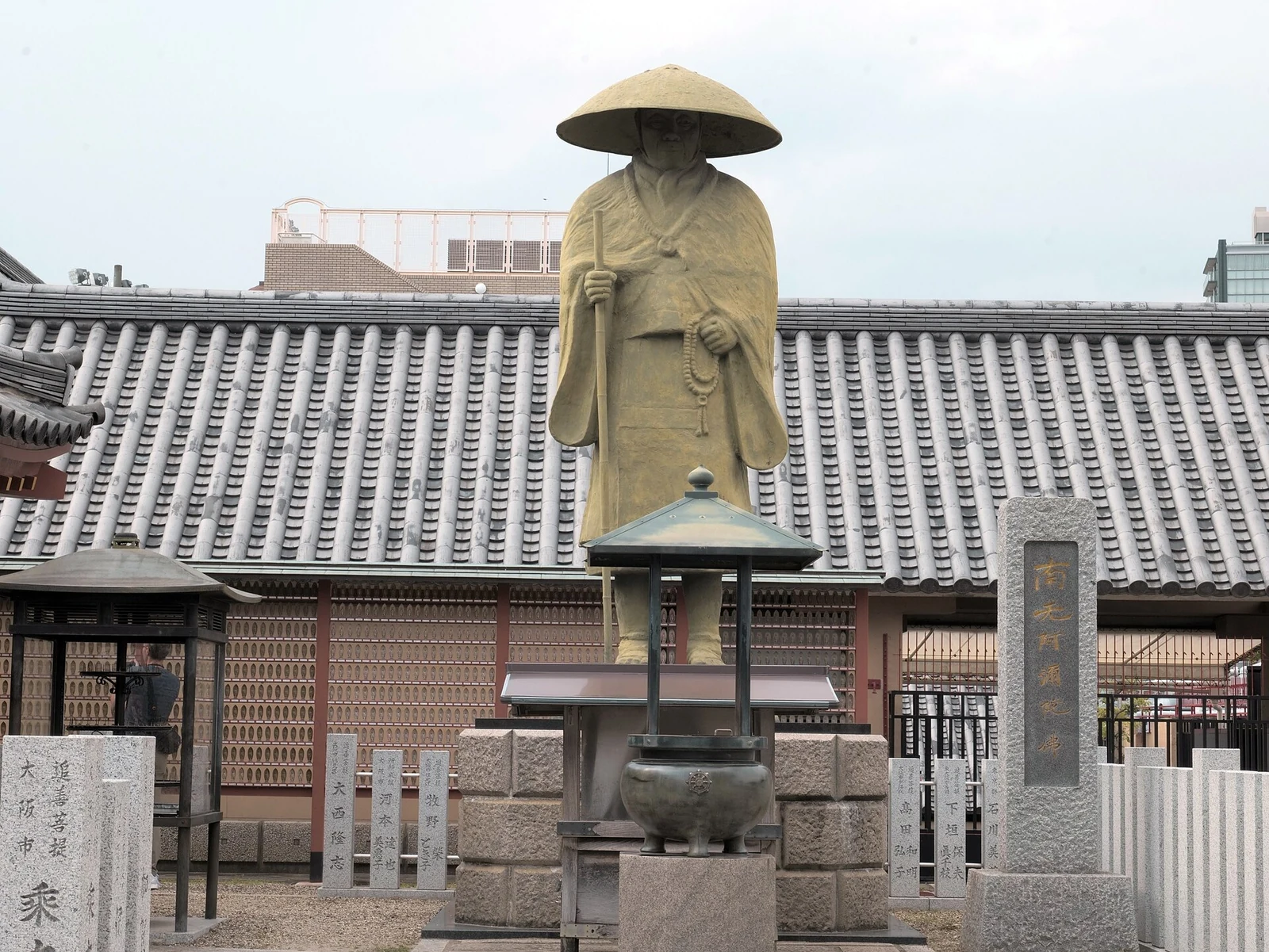 A statue and temple building within Shitennoji.