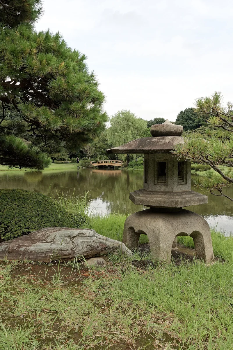 A stone lantern among the greenery in Shinjuku Gyoen.